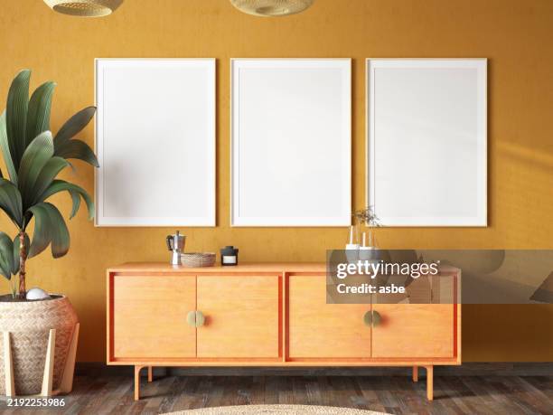 three empty mock up picture frames on modern room's wall - wall poster mockup stock pictures, royalty-free photos & images