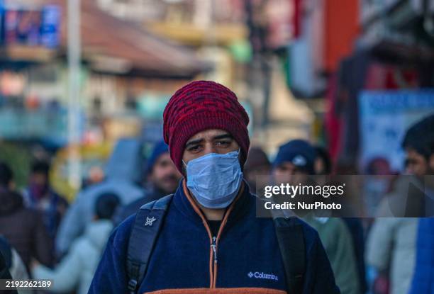 Man wearing a protective face mask walks along a road in Srinagar, Jammu and Kashmir, on December 7, 2025. India reports seven cases of the Human...