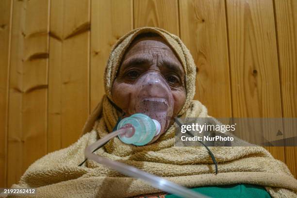 An elderly woman receives nebulizer treatment in Srinagar, Jammu and Kashmir, on December 7, 2025. India reports seven cases of the Human...