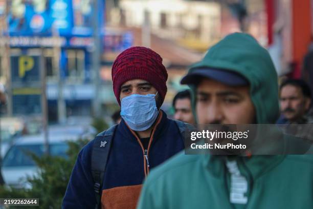 Man wearing a protective face mask walks along a road in Srinagar, Jammu and Kashmir, on December 7, 2025. India reports seven cases of the Human...