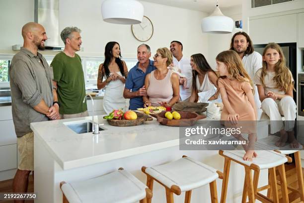 adults and children gathered in kitchen for family party - kitchen island stock pictures, royalty-free photos & images