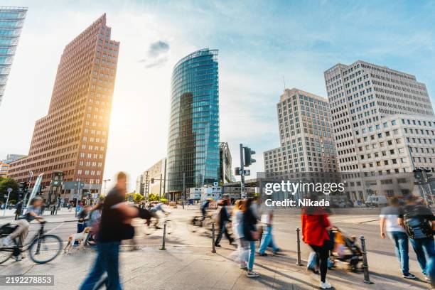 dynamic urban scene in berlin potsdamer platz - pedestrian zone stock pictures, royalty-free photos & images