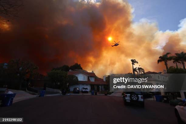 Plumes of smoke are seen as a brush fire burns in Pacific Palisades, California on January 7, 2025. A fast-moving brushfire in a Los Angeles suburb...