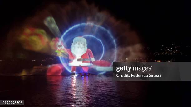 christmas-themed laser light projection on lake maggiore, verbania pallanza, northern italy. part of the unesco biosphere reserve ticino valgrande verbano. - laser light show stock pictures, royalty-free photos & images