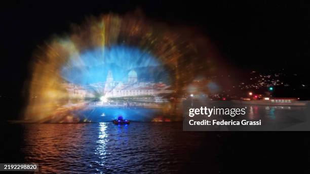 christmas-themed laser light projection on lake maggiore, verbania pallanza, northern italy. part of the unesco biosphere reserve ticino valgrande verbano. - laser light show stock pictures, royalty-free photos & images
