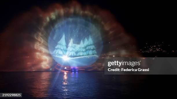 christmas-themed laser light projection on lake maggiore, verbania pallanza, northern italy. part of the unesco biosphere reserve ticino valgrande verbano. - laser light show stock pictures, royalty-free photos & images