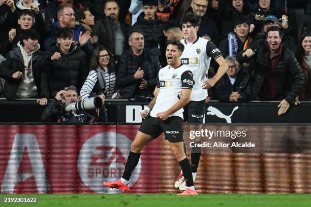 Hugo Duro of Valencia CF celebrates scoring his team's first goal with teammate Javi Guerra during the LaLiga match between Valencia CF and Real...
