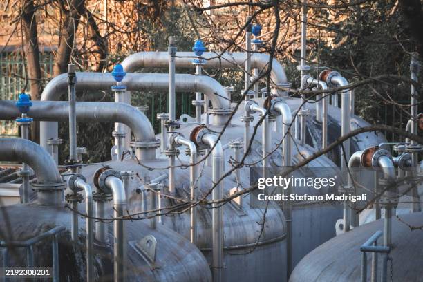 a series of pipes and valves arranged in a row - nitrogen stock pictures, royalty-free photos & images