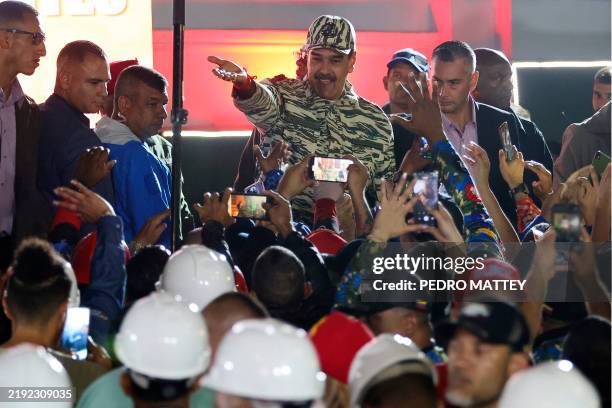 Venezuela's President Nicolás Maduro greets supporters during a swearing-in march for combatant forces in Caracas on January 7, 2025. On January 10,...