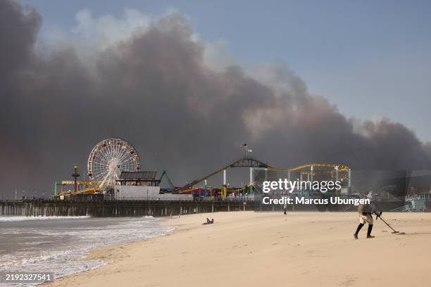 Santa Monica, CA The Palisades fire burns in the distance. Santa Monica Pier on Tuesday, Jan. 7, 2025 in Santa Monica, CA.