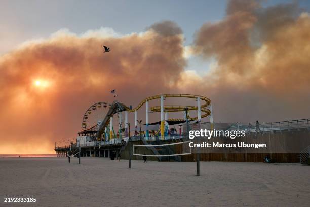 Santa Monica, CA The Palisades fire burns in the distance. Santa Monica Pier on Tuesday, Jan. 7, 2025 in Santa Monica, CA.