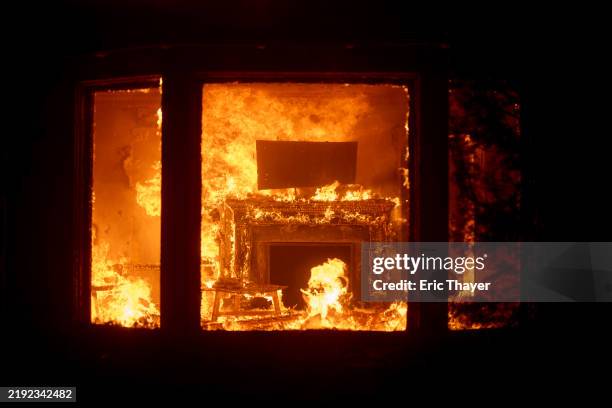 Flames from the Palisades Fire burn a home on January 7, 2025 in the Pacific Palisades neighborhood of Los Angeles, California.