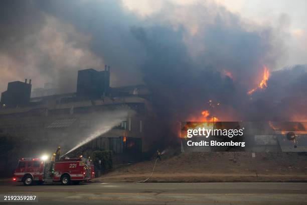 Firefighters battle the blaze on Sunset Boulevard during the Palisades Fire in the Pacific Palisades neighborhood of Los Angeles, California, US, on...
