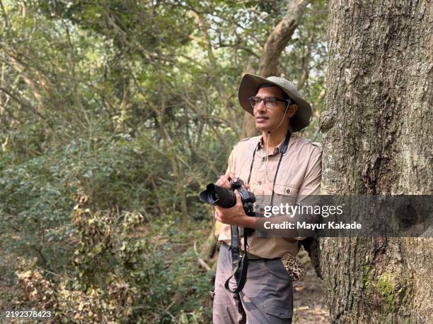 wild life photographer with his camera as he waits for the wild life in bhitarkanika mangrove forest, odisha - bird watching stock pictures, royalty-free photos & images