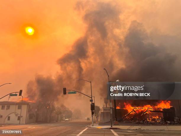 Flames from the wind-driven Eaton Fire engulf a house in Altadena, California, January 8, 2025. A ferocious wildfire in a Los Angeles suburb devoured...