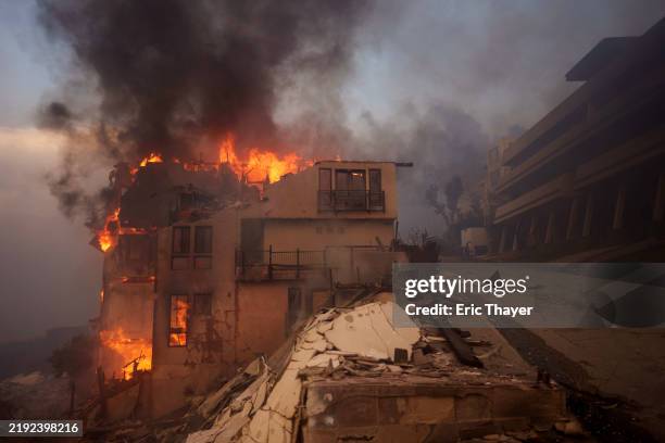 Flames from the Palisades Fire burn a structure on January 8, 2025 in Malibu, California. Fueled by intense Santa Ana Winds, the Palisades Fire has...