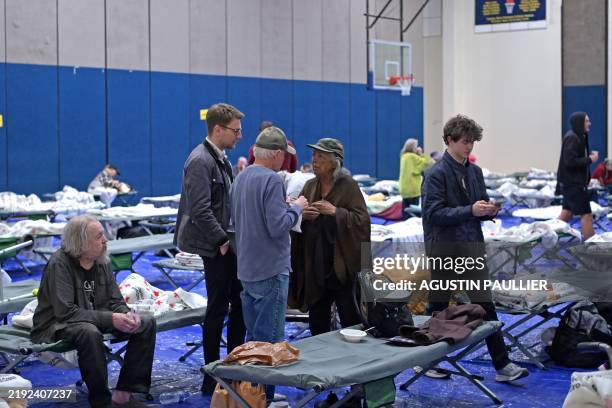 Evacuees from the Palisades fire are seen at an evacuation and shelter center at Westwood Recreation Center in Los Angeles, California, on January 8,...