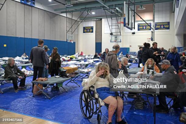 Evacuees from the Palisades fire are seen at an evacuation and shelter center at Westwood Recreation Center in Los Angeles, California, on January 8,...