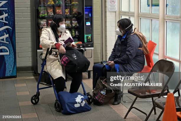 Evacuees from the Palisades fire are seen at an evacuation and shelter center at Westwood Recreation Center in Los Angeles, California, on January 8,...