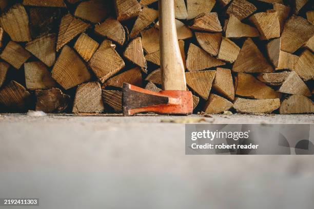 wood pile and axe - axe stock pictures, royalty-free photos & images