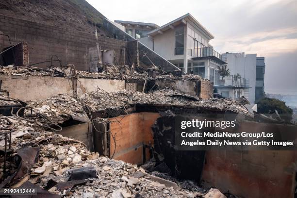 January 08: Homes destroyed and homes saved above Pacific Coast Highway in Malibu, CA on Wednesday, January 8, 2025. High winds escalated the spread...