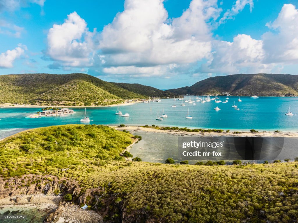 Beautiful BVI British Virgin Island Sailing destination. Aerial view of Catamaran in front of beach and famous sailing destination