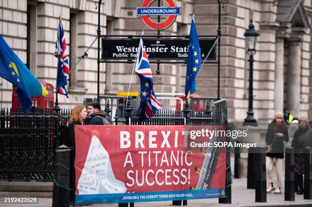 Banner that says "Brexit: a Titanic success" is seen outside Westminster station during the demonstration. Activists held their weekly anti-Brexit...