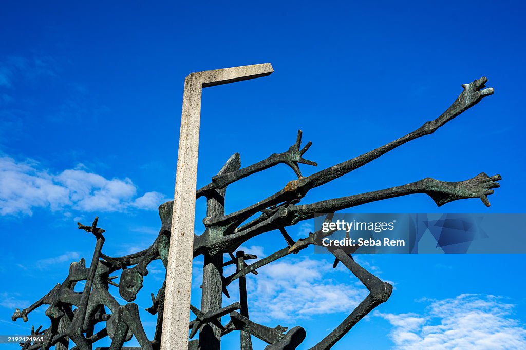The salaspils memorial, a poignant reminder of the atrocities committed during world war ii, stands tall against a vibrant blue sky, symbolizing the suffering and resilience of the victims