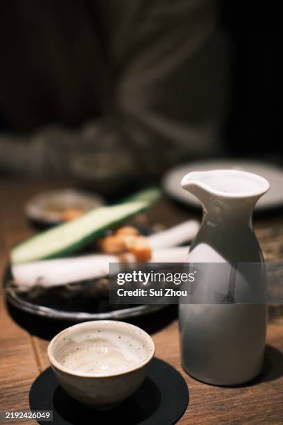 drinking sake - sake cup stock pictures, royalty-free photos & images