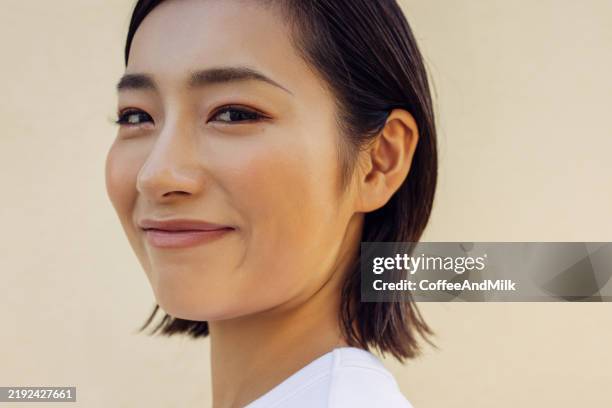 woman smiling joyfully in a close-up portrait - korean people stock pictures, royalty-free photos & images