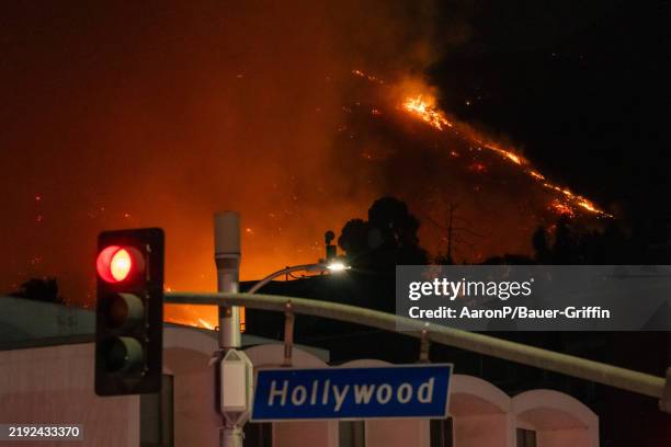 Flames are seen on the hillsides above Hollywood Blvd. During the Sunset Fire on January 08, 2025 in Hollywood, California.