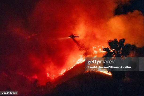 Helicopters are seen making water drops during the Sunset Fire on January 08, 2025 in Hollywood, California.