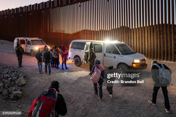 Migrants turn themselves in to U.S. Customs and Border Patrol officers after crossing over a section of border wall into the U.S. On January 05, 2025...