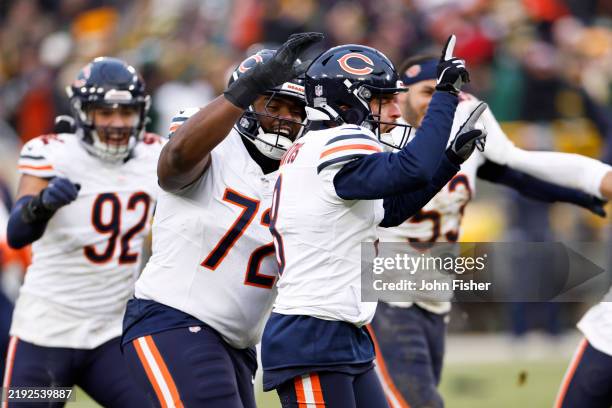 Cairo Santos of the Chicago Bears celebrates with teammates after kicking a field goal to beat the Green Bay Packers 24-22 at Lambeau Field on...
