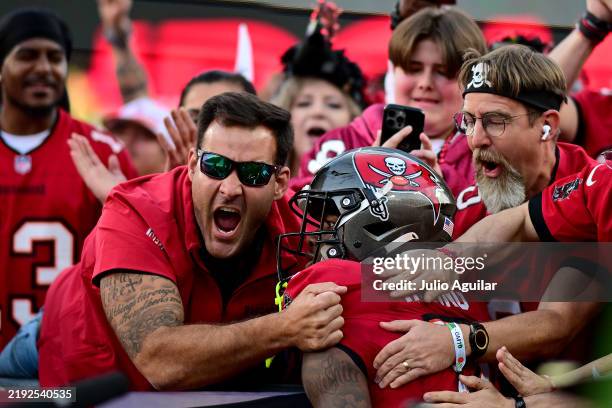 Bucky Irving of the Tampa Bay Buccaneers celebrates with fans after scoring a touchdown against the New Orleans Saints in the fourth quarter of the...