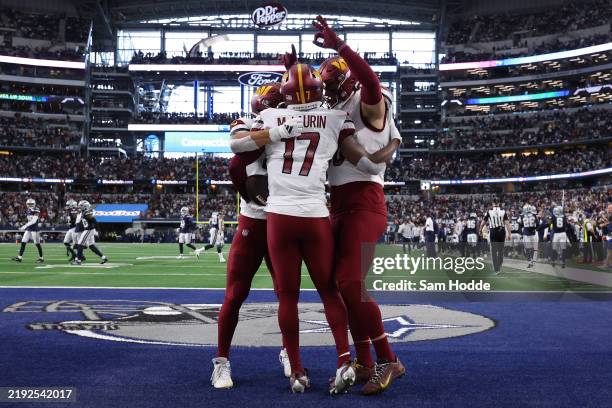 Terry McLaurin of the Washington Commanders celebrates scoring a touchdown with teammate Zach Ertz against the Dallas Cowboys during the fourth...