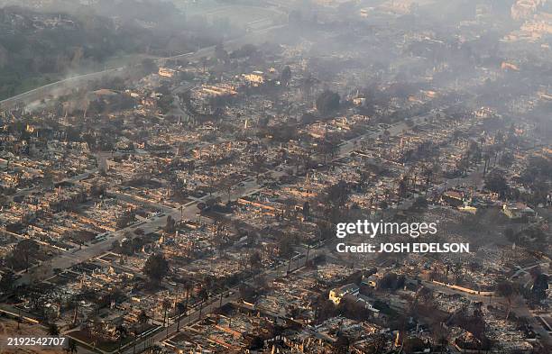In this aerial view taken from a helicopter, burned homes are seen from above during the Palisades fire near the Pacific Palisades neighborhood of...