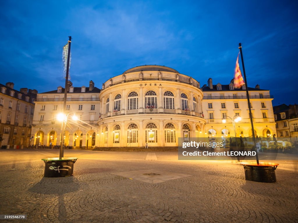 Wide angle view of the illuminated facade of Rennes Opera House building (Opéra de Rennes) at night, as seen from the town hall cobblestone square of the historic district of Rennes, IIle-et-Vilaine - Brittany (Bretagne) - Western France.
