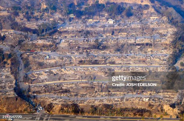 In this aerial view taken from a helicopter, burned homes are seen from above during the Palisades fire in Los Angeles county, California on January...