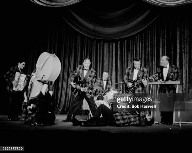 Rock and Roll singer Bill Haley, third left, during a performance with his band Bill Haley & His Comets, including accordion player Johnny Grande,...