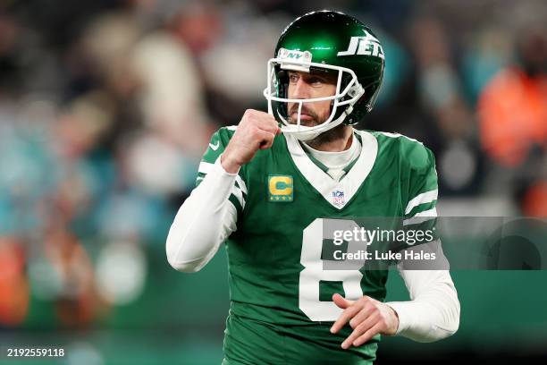 Aaron Rodgers of the New York Jets reacts after a touchdown against the Miami Dolphins during the fourth quarter at MetLife Stadium on January 05,...