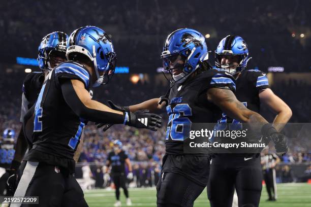 Jahmyr Gibbs of the Detroit Lions celebrates a touchdown with Amon-Ra St. Brown during the first quarter against the Minnesota Vikings at Ford Field...