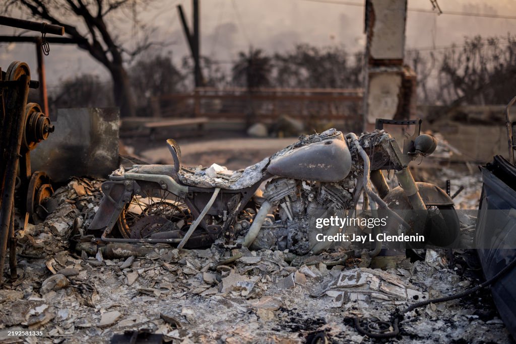 Motorcycle Engine Destroyed A destroyed motorcycle is seen cover by ashes of houses burned during ...