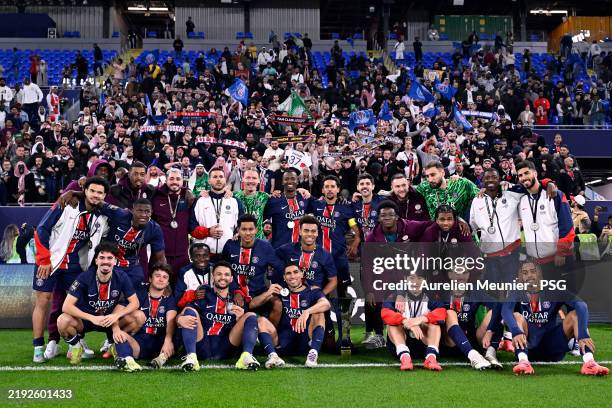 Paris Saint-Germain players pose with the Trophy after winning the Trophée des Champions match against Monaco at Stadium 974 on January 05, 2025 in...