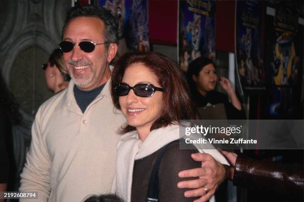 Cuban-American musician and record producer Emilio Estefan, wearing a white top with the sleeves rolled up and sunglasses, and his wife...