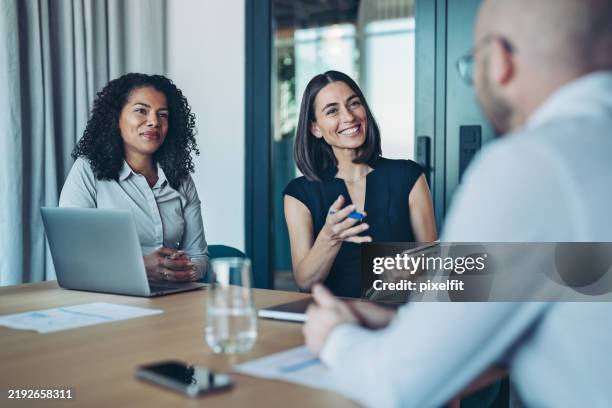 focus on couple of businesswomen during a meeting - financial planning stock pictures, royalty-free photos & images