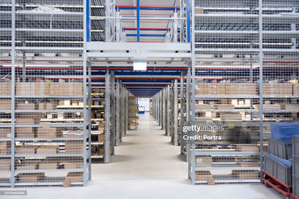 Warehouse interior showing aisle and storage racks of goods