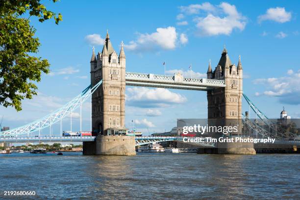 two red double decker buses crossing tower bridge, london, uk - historic building stock pictures, royalty-free photos & images