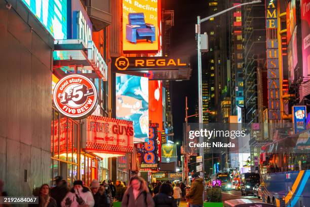 times square night view with neon city lights and urban vibes - digital signage stock pictures, royalty-free photos & images