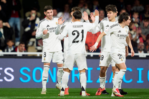 Federico Valverde of Real Madrid CF celebrates with his teammates after scoring his team's first goal during the Copa del Rey Round of 32 match...